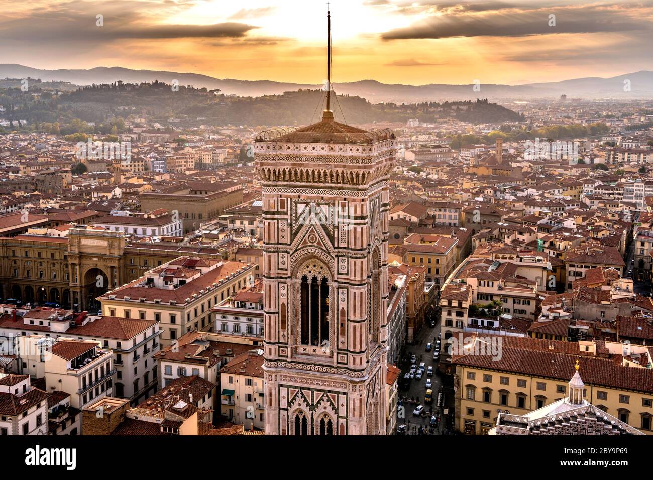 Sunset Florence - Colorful sunset view of Giotto's Campanile and Old Town of Florence, as seen from top of Brunelleschi's Dome of Florence Cathedral. Stock Photo