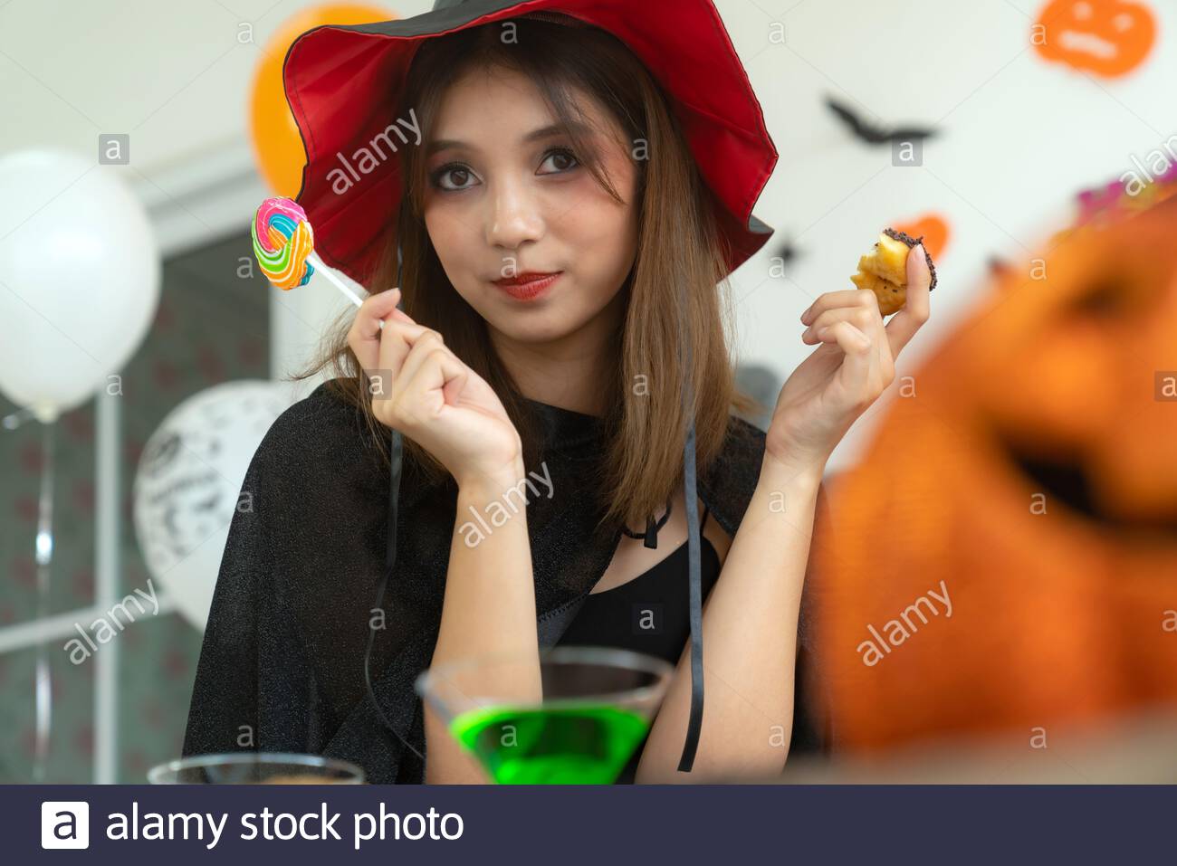 Beautiful Young Adult And Teenager Girl Celebrating A Halloween Party Carnival Festival In Halloween Costumes With Food And Drink On Table Stock Photo Alamy