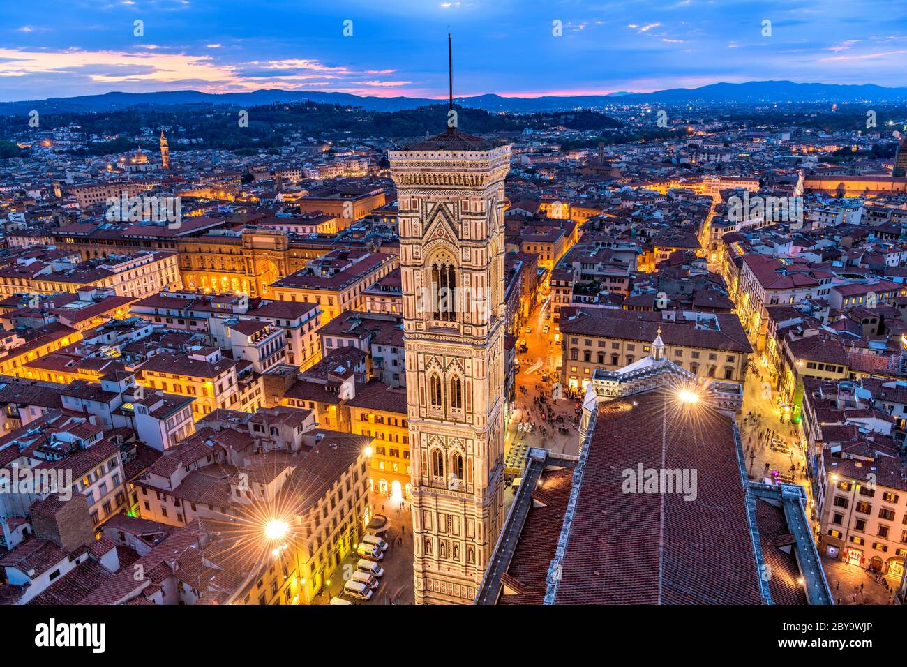 Giotto's Campanile - Aerial dusk view of Giotto's Campanile and Old Town of Florence, as seen from top of Brunelleschi's Dome of Florence Cathedral. Stock Photo
