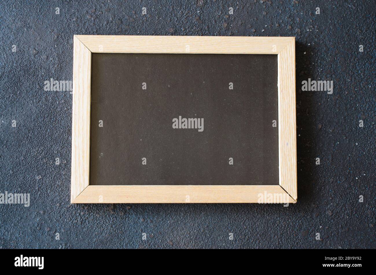 Empty blackboard background. Blank chalkboard in wooden frame. Stock Photo