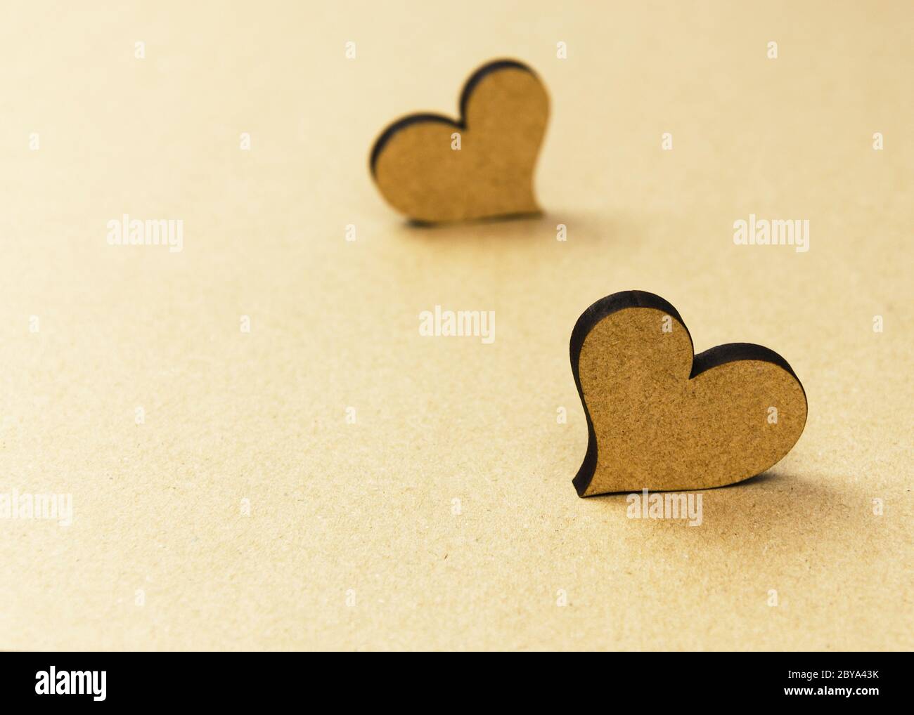 two wooden hearts on craft background Stock Photo