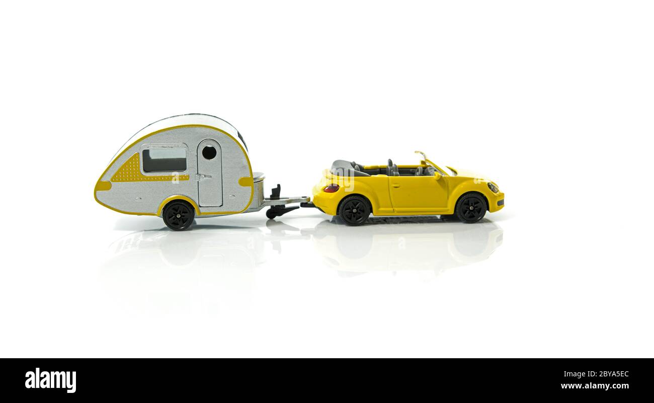 caravan and yellow car for vacation on camping ground isolated on white background Stock Photo