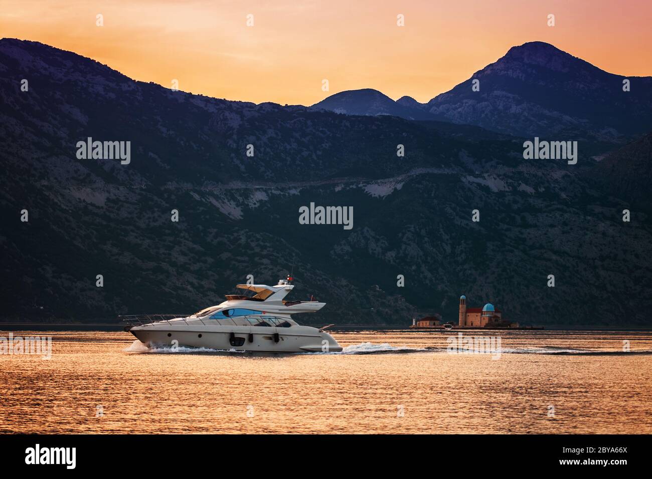 speedboat in the sunset sea on mountains background Stock Photo