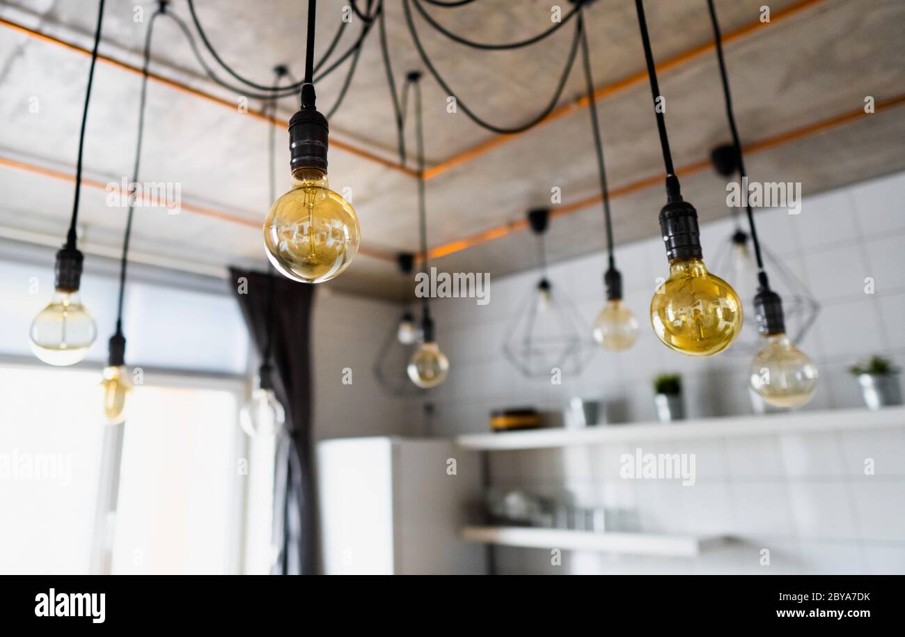 Big incandescent light bulbs hanging modern kitchen. Decorative antique edison light bulbs with straight wire. Inefficient filament light Stock - Alamy