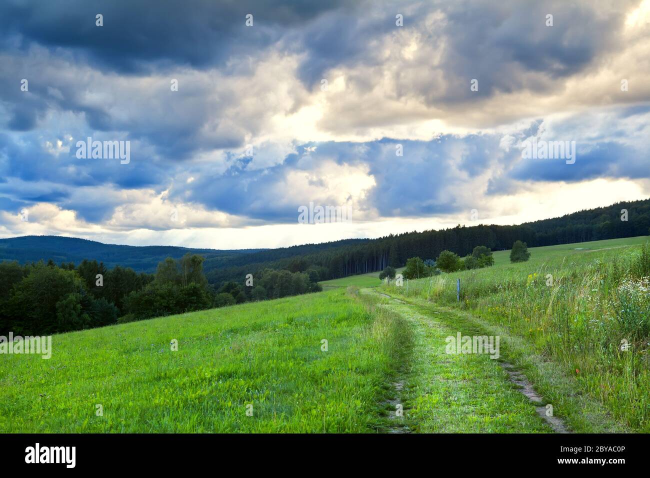 dramatic cloudscape over rural road Stock Photo