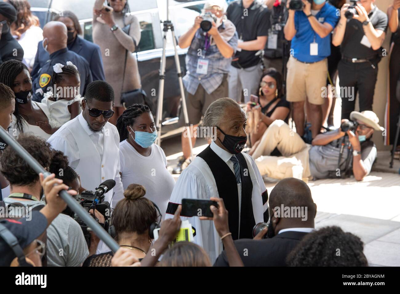 Family members along with Reverend AL Sharpton prepare to enter the sanctuary of Fountain of Praise Church in Houston on June 9, 2020 for the funeral service honoring the life of GEORGE FLOYD. Floyd 's death 2 weeks ago at the hands of a white policeman, set off hundreds of protests worldwide against police brutality and racism. Stock Photo