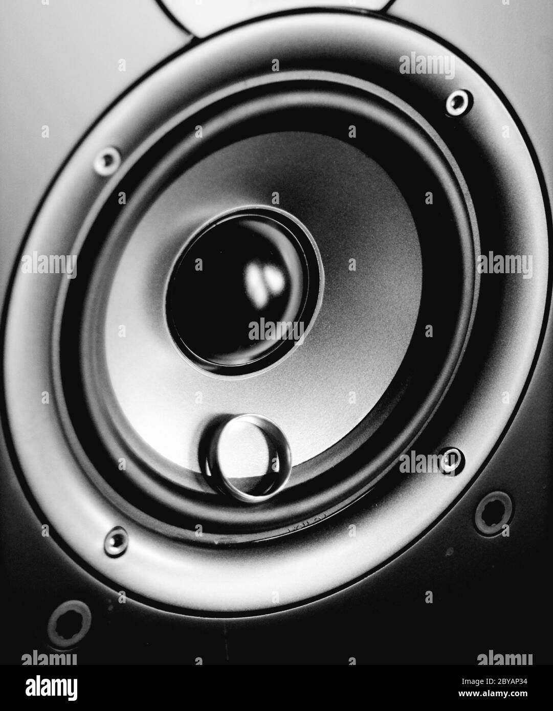 BLACKHOLE HORIZON: A gold ring spins along the axis of revolving speaker. Stock Photo