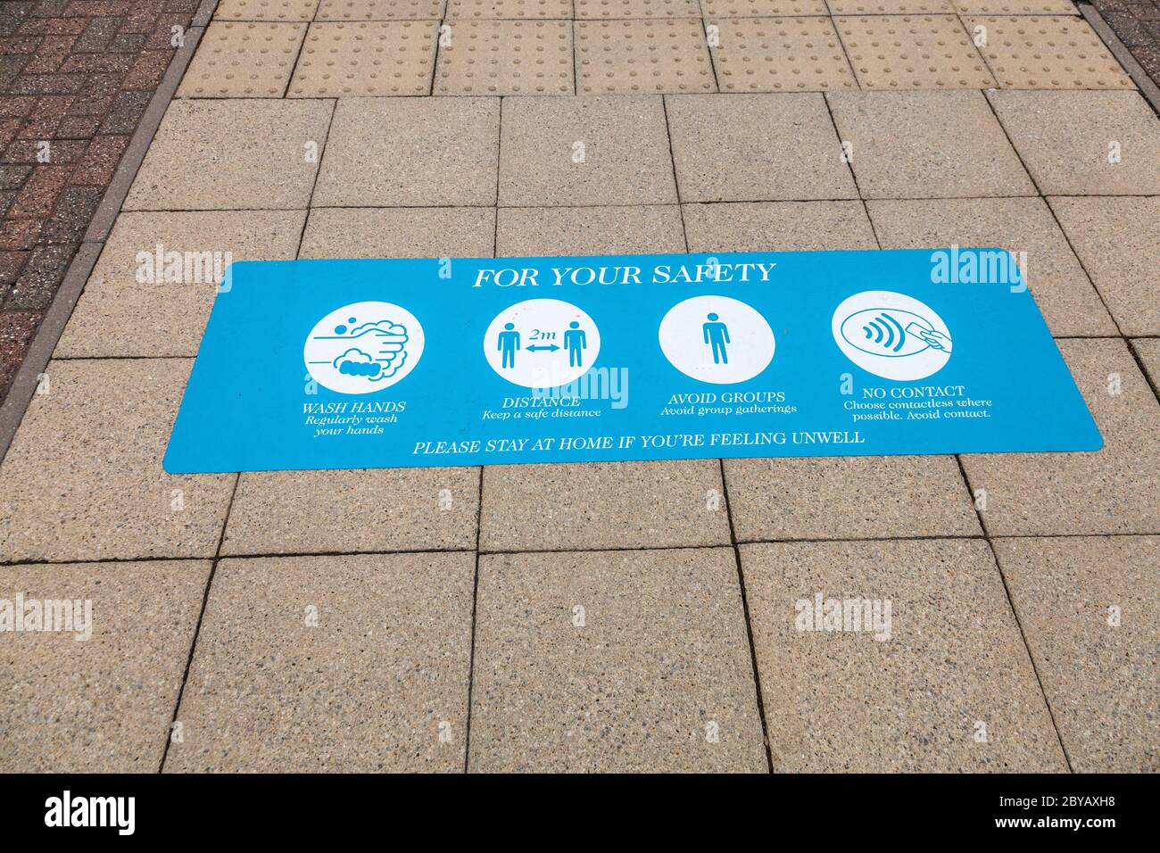 Covid 19, instructions and guidance on pavements at Teesside Park, Thornaby, Stockton on Tees, England, UK Stock Photo