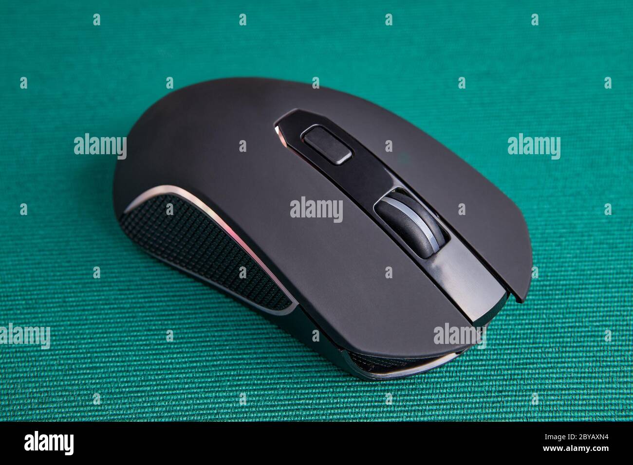 Wireless gaming computer mouse in black, with led light on green  background. Battery powered input device to control the cursor on the PC  screen Stock Photo - Alamy