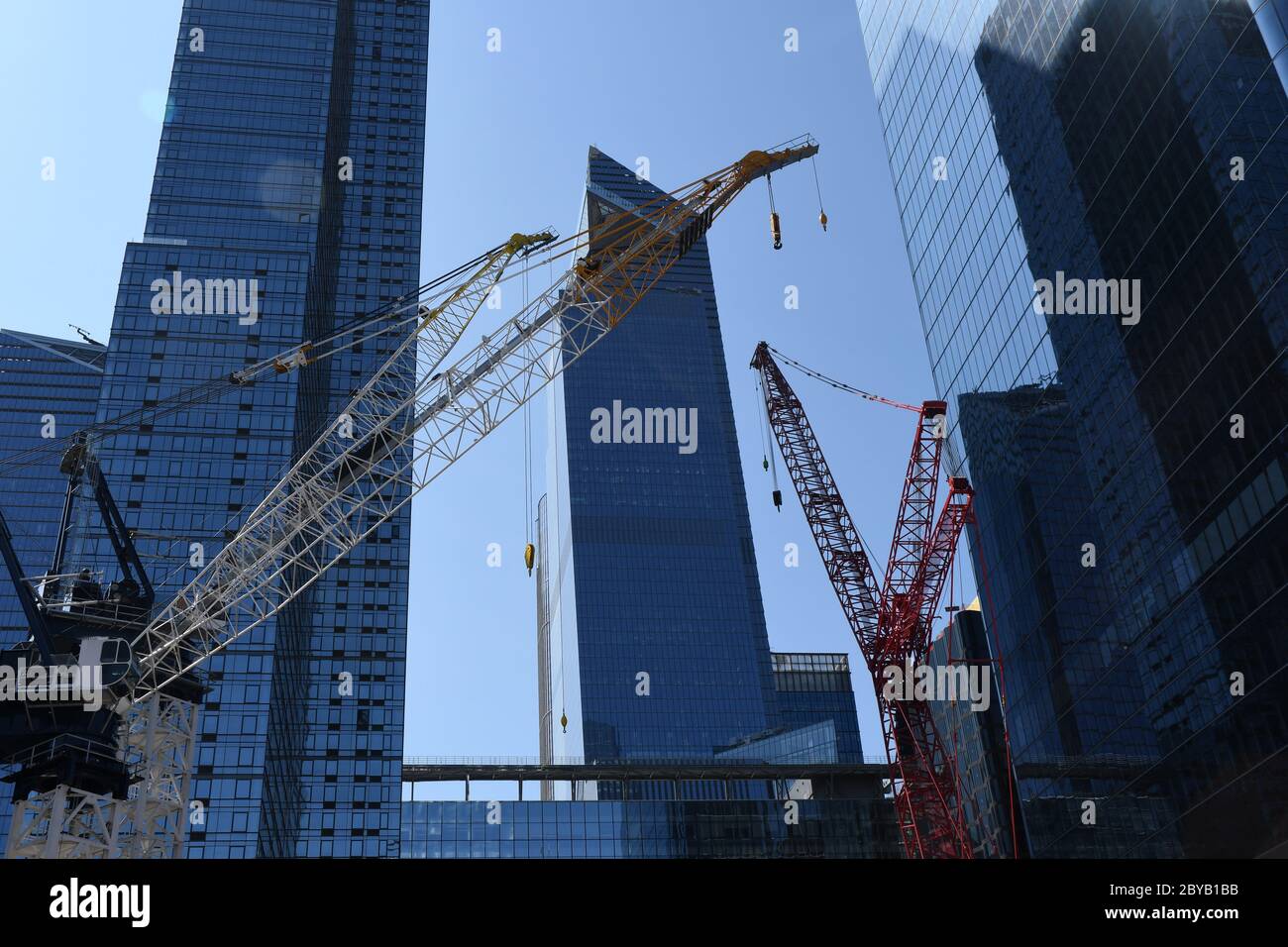 RISING SKY: High into the heavens of the sky and as imaginative and architecturally masterful as ever before a brand new Manhattan rises. Stock Photo