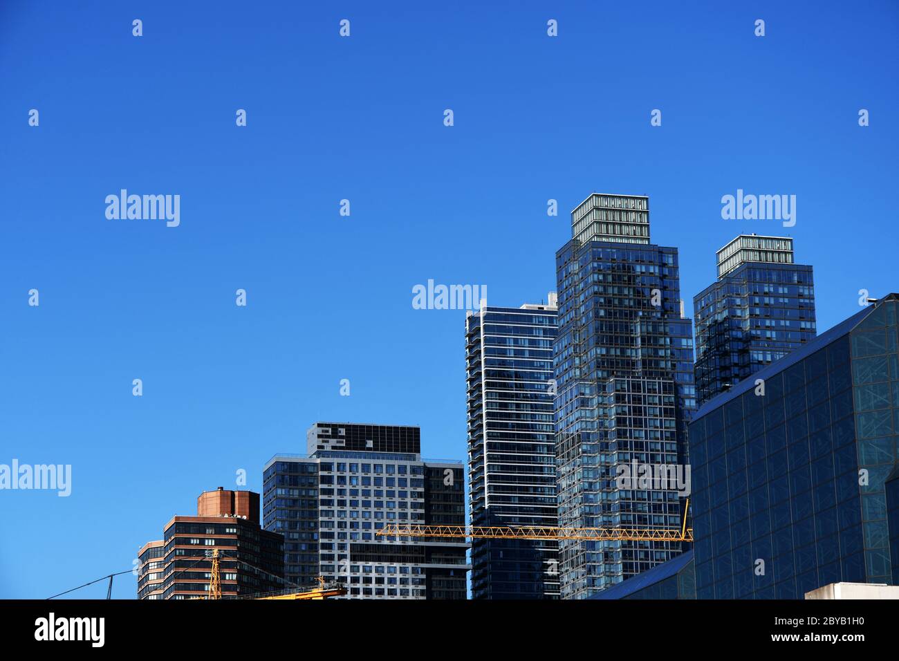 RISING SKY: High into the heavens of the sky and as imaginative and architecturally masterful as ever before a brand new Manhattan rises. Stock Photo