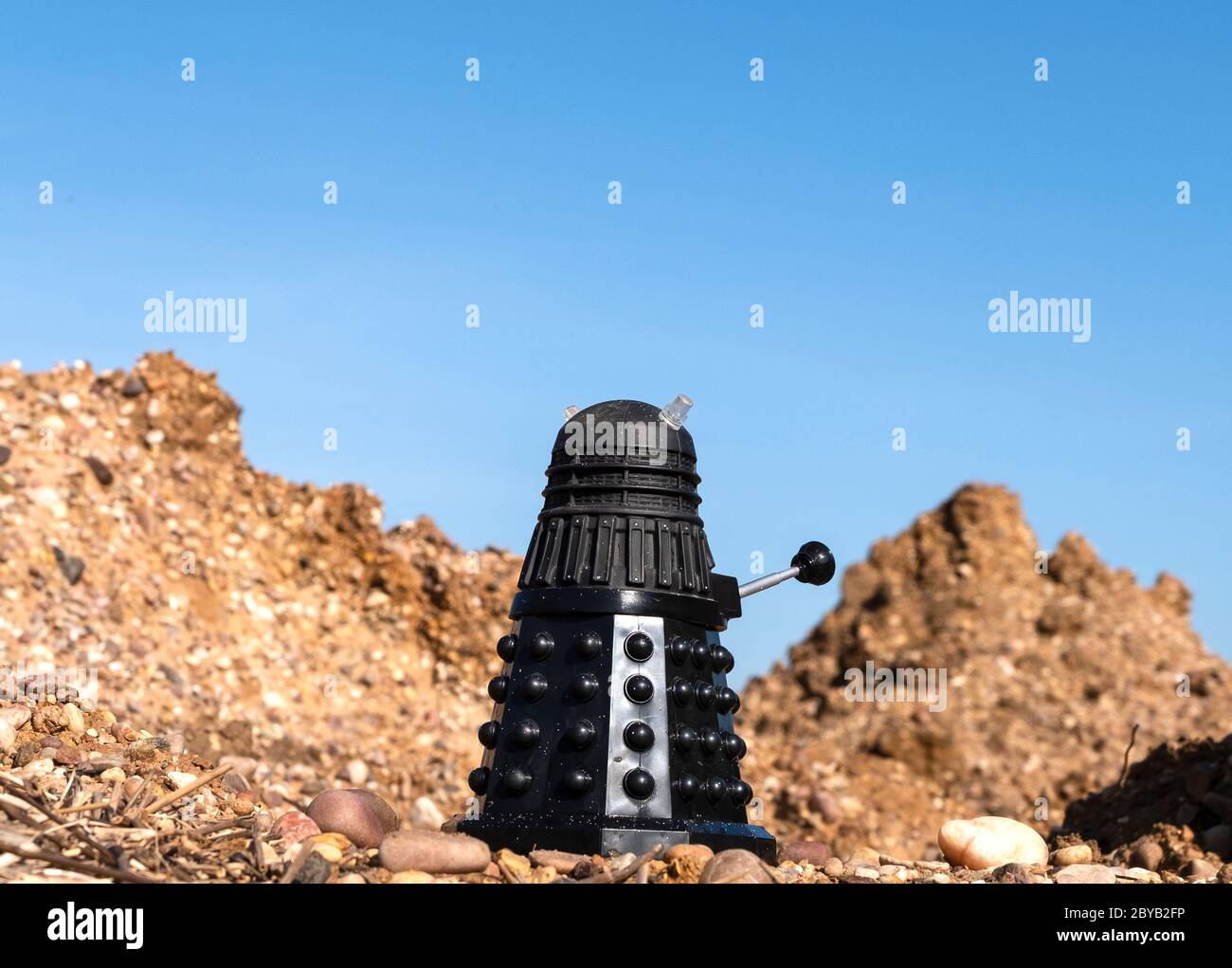 Black Dalek in a barren landscape Stock Photo