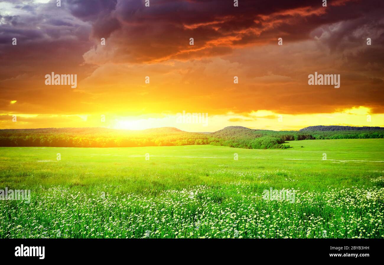 Rising sun with dark clouds Stock Photo