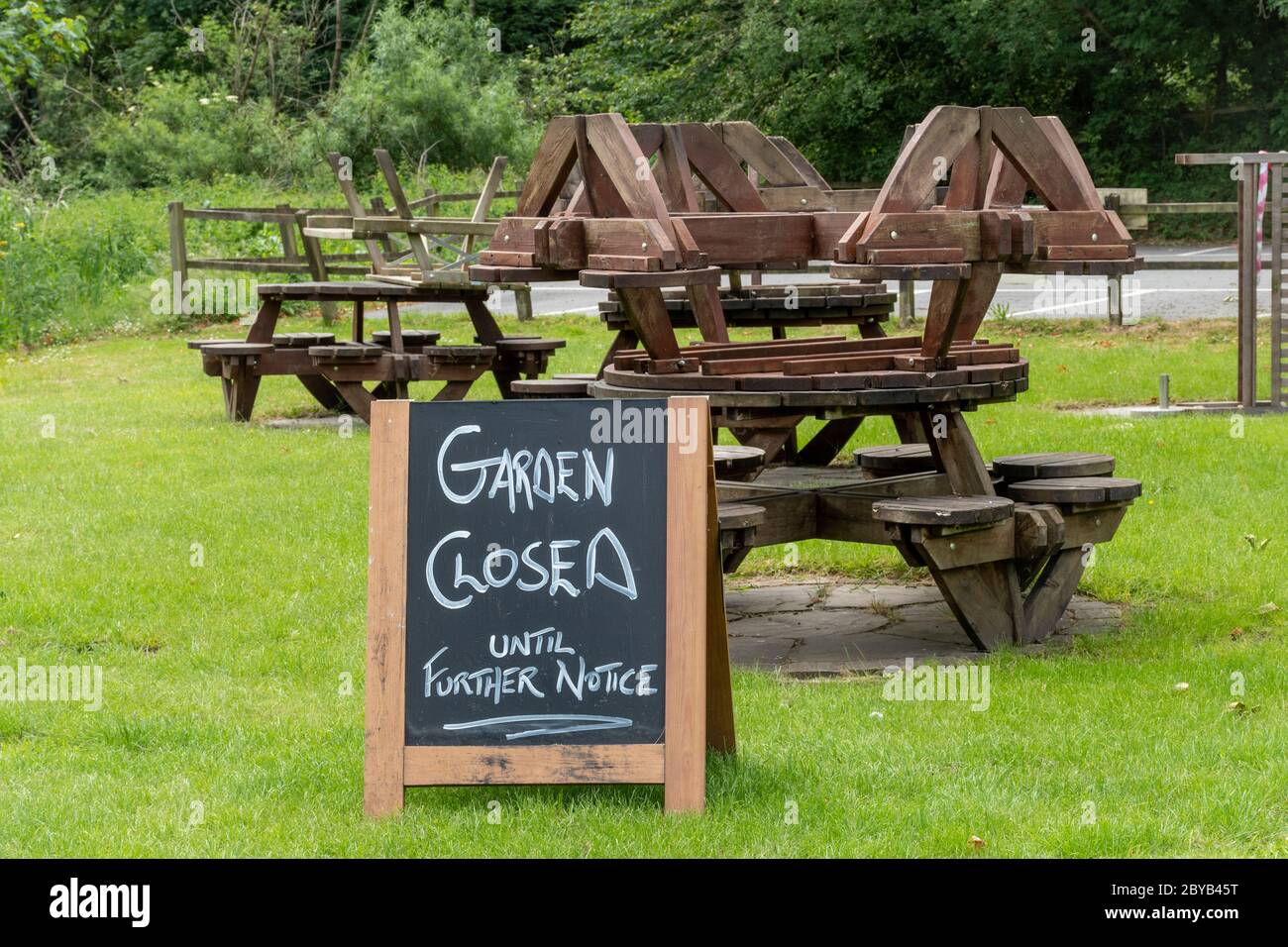 Pub beer garden closed during the 2020 coronavirus covid-19 pandemic with tables piled up, UK Stock Photo