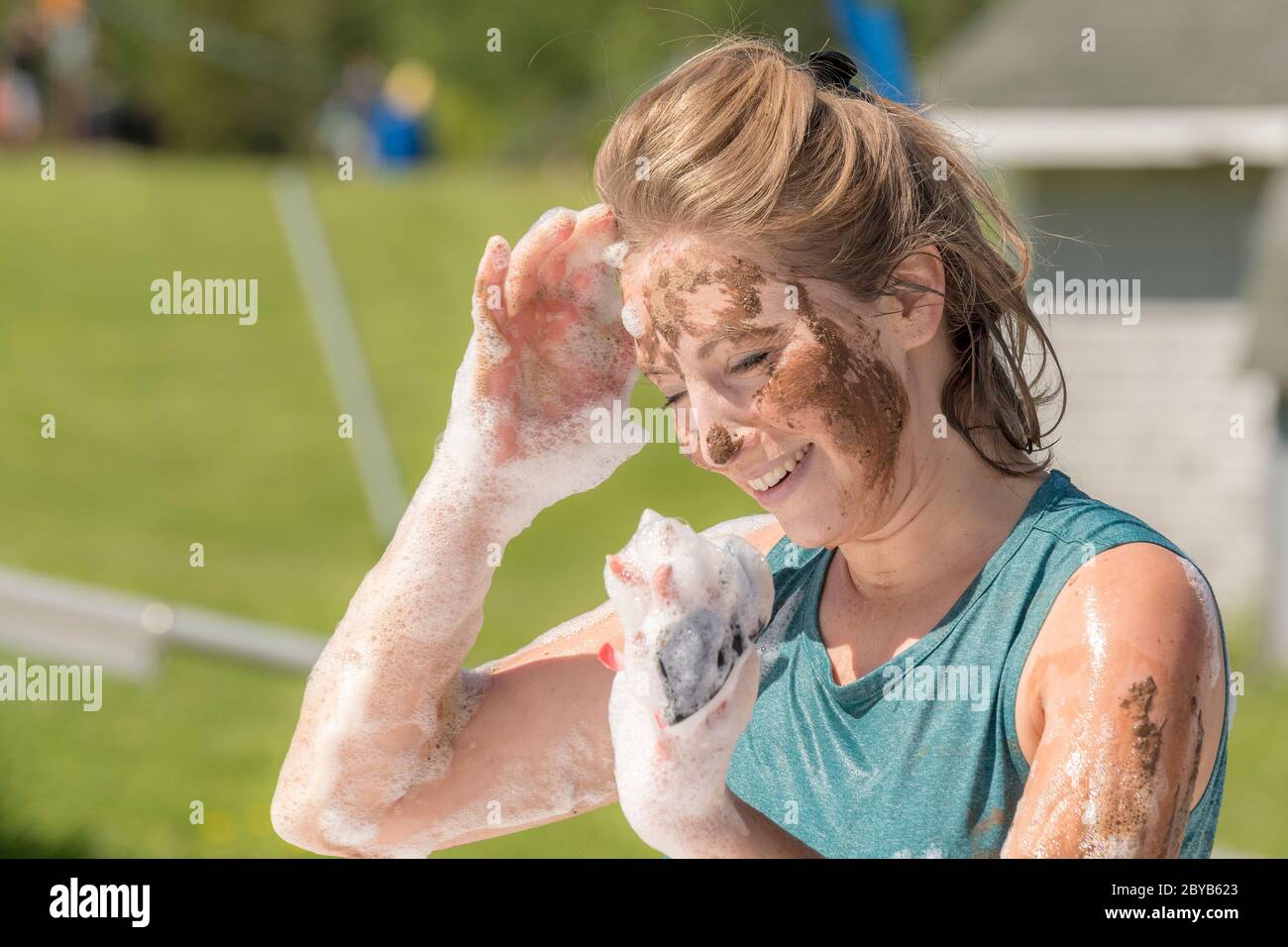 Poley Mountain, New Brunswick, Canada - June 10, 2017: Participating in the annual fundraiser 'Mud Run For Heart'. A woman covered with mud and soap s Stock Photo