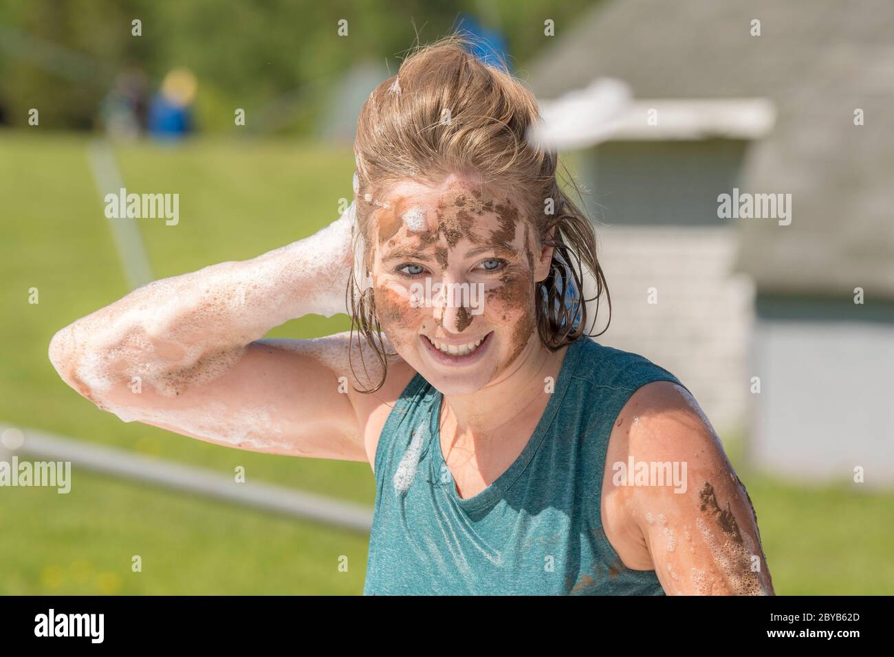 Poley Mountain, New Brunswick, Canada - June 10, 2017: Participating in the annual fundraiser 'Mud Run For Heart'. A woman covered with mud and soap s Stock Photo