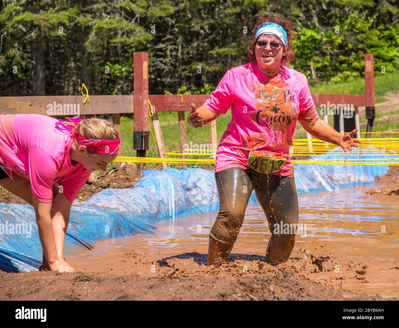 Poley Mountain, New Brunswick, Canada - June 10, 2017: Participating in the annual fundraiser 'Mud Run For Heart'. Standing in mud and water. Stock Photo