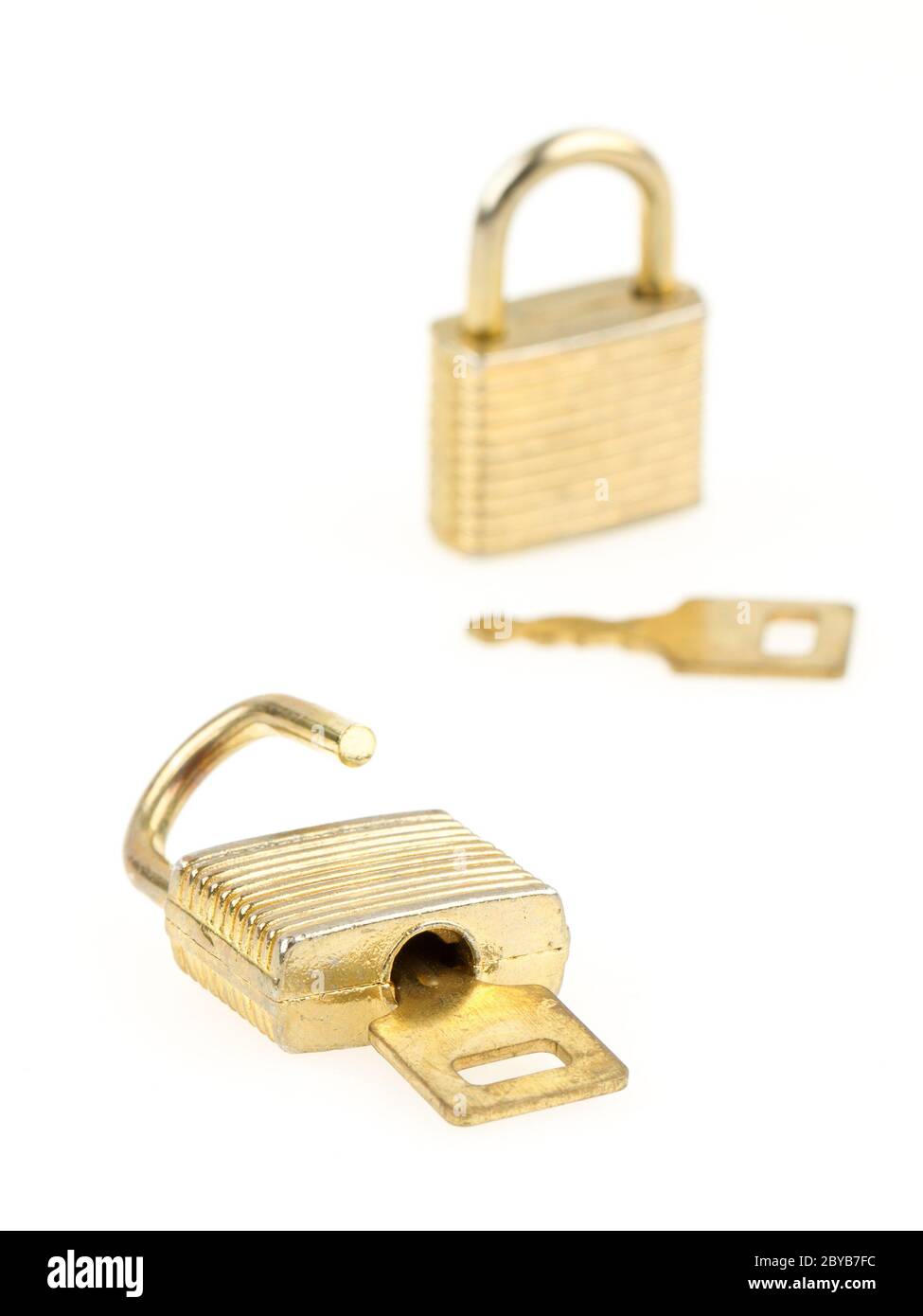 Opened en closed padlocks and keys isolated, focus in the front Stock Photo