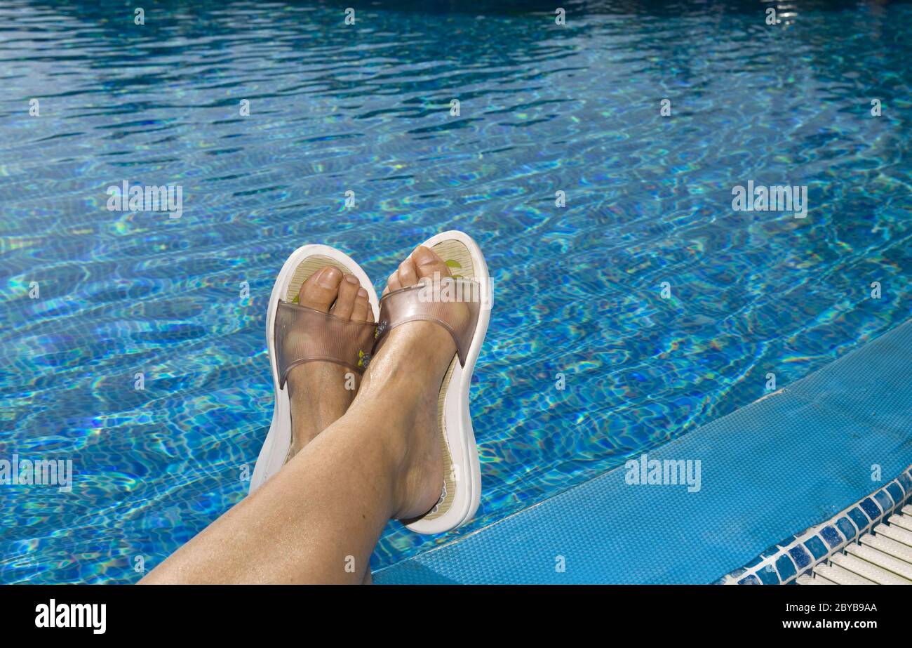 Feet in beach slippers Stock Photo - Alamy