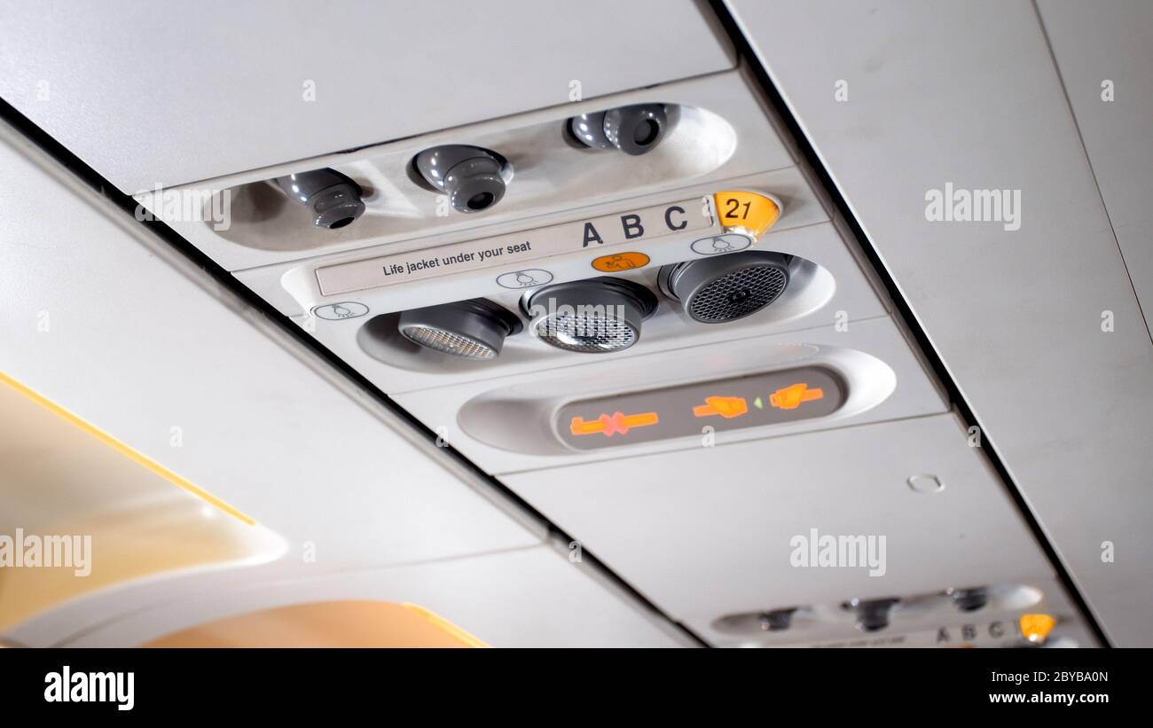 Closeup image of air ventilation system and reading lamps on airplane