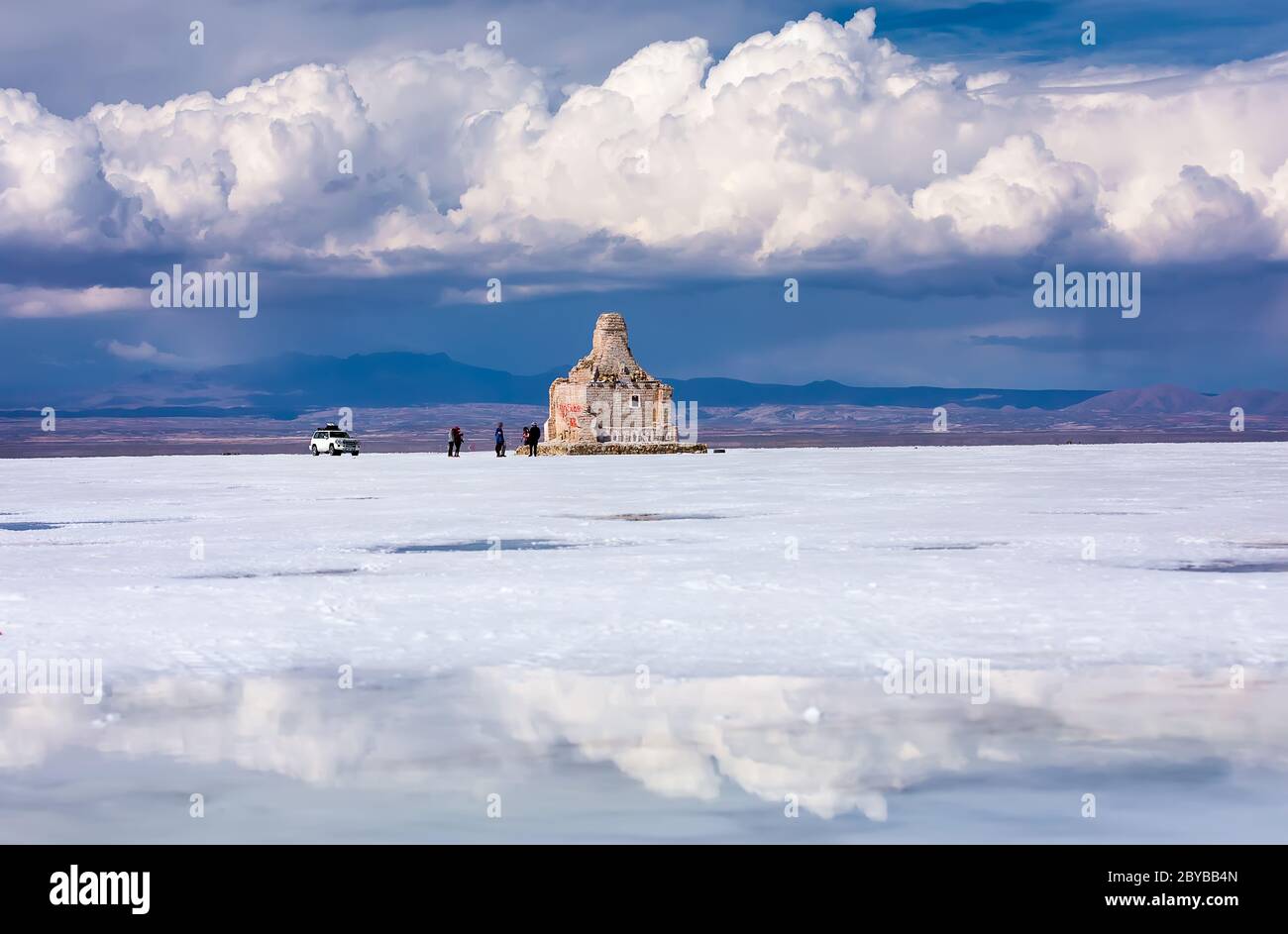 Stunning view on Salt flat of Uyuni with Statue Dakar Rally and reflection of clouds. Daniel Campos Province, Bolivia Stock Photo