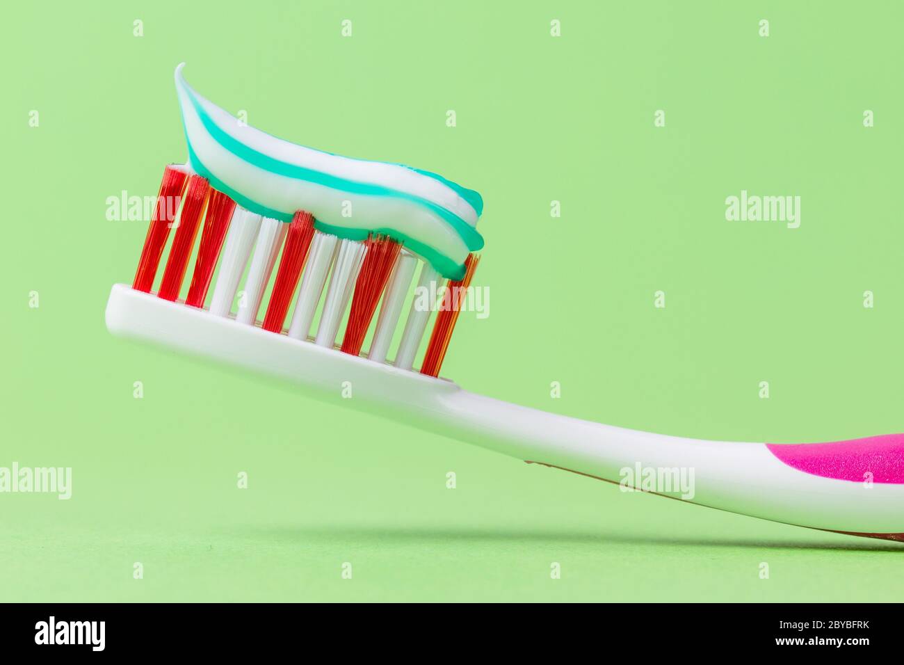 A pink toothbrush with toothpaste Stock Photo Alamy