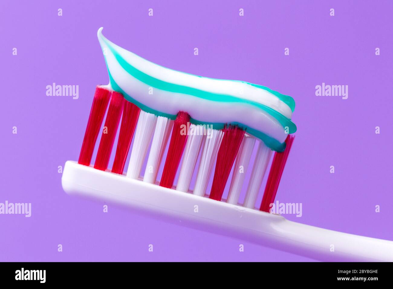 A pink toothbrush with toothpaste Stock Photo Alamy