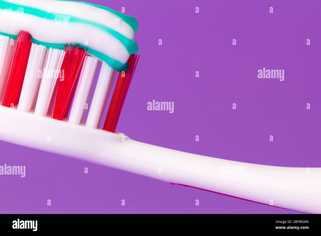 A pink toothbrush with toothpaste Stock Photo Alamy