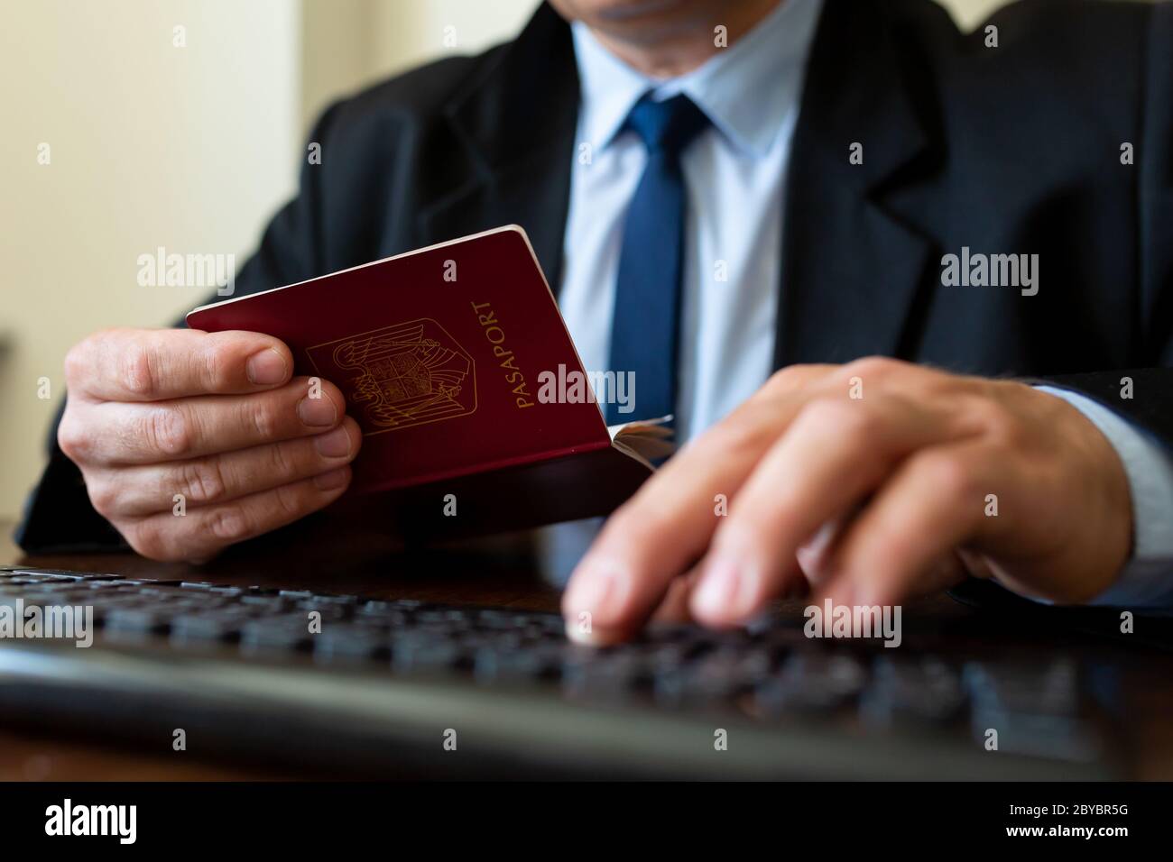 Close up. The immigration control officer verifies passport