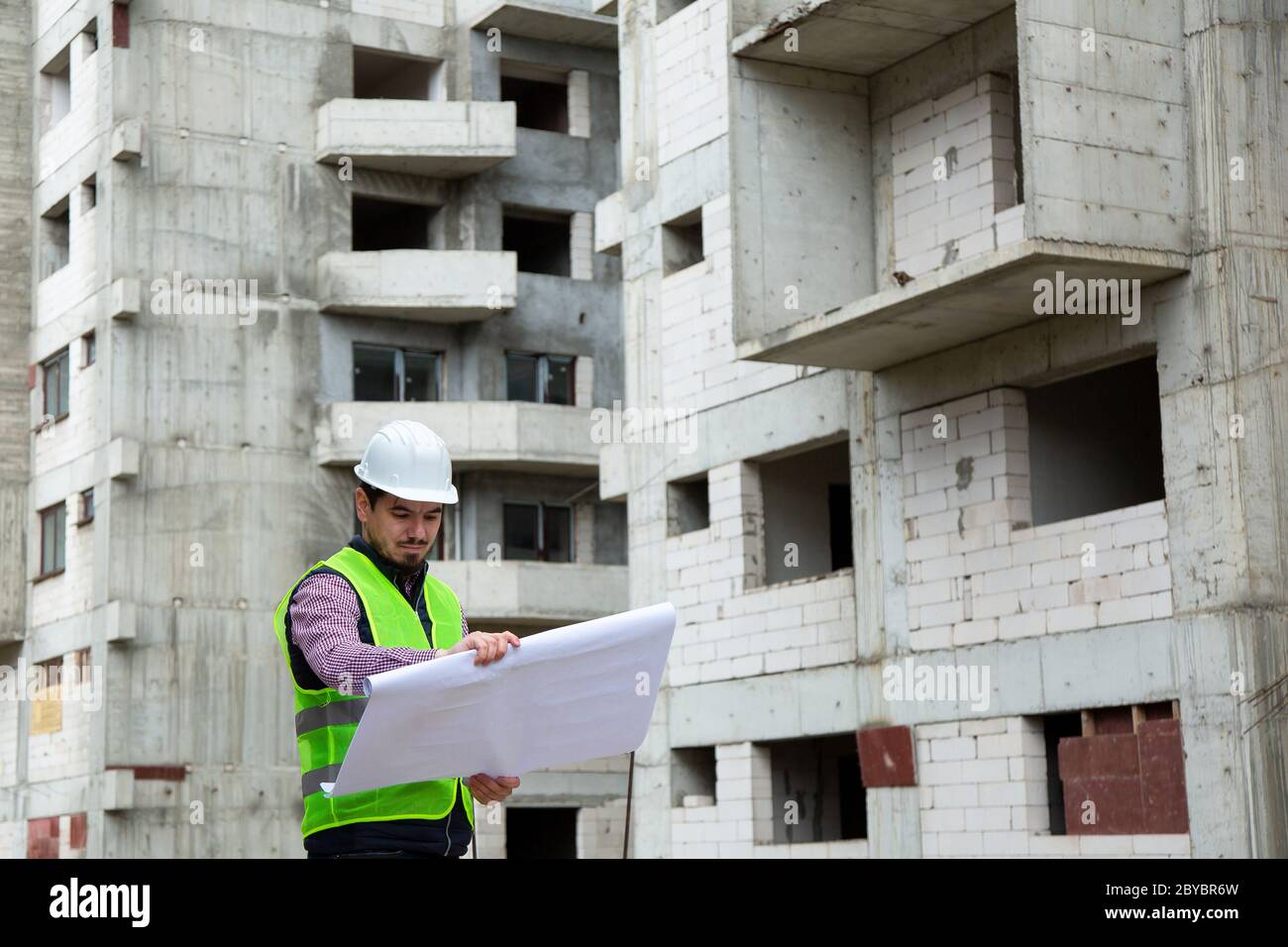 Young Engineer Working on Building Site Stock Photo