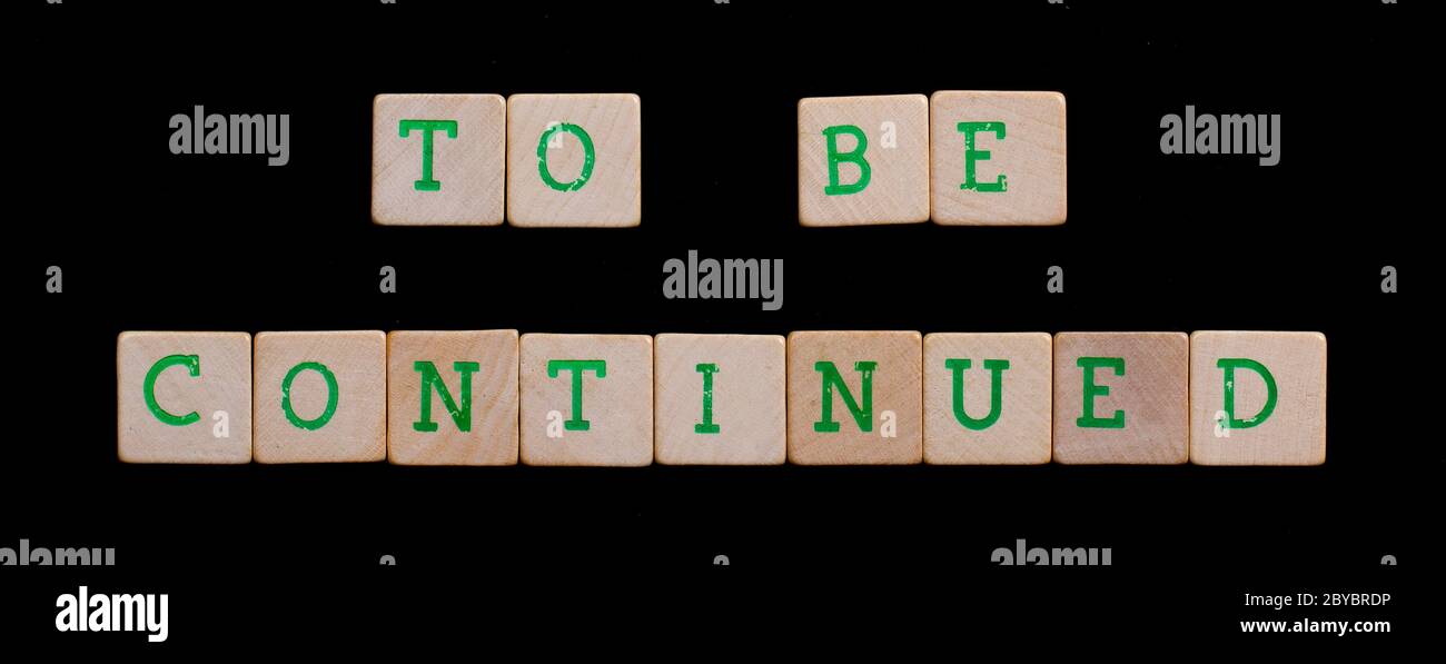 Green letters on old wooden blocks (to be continued Stock Photo - Alamy