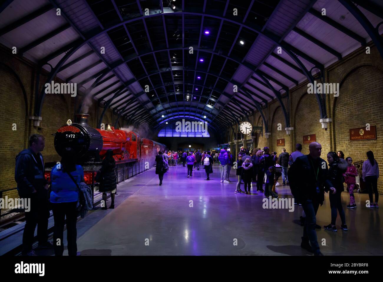 London, UK -  February 2020: Visitors at platform 9 3/4 and Hogwarts Express in Warner Brothers Harry Potter Studio Tour. Stock Photo