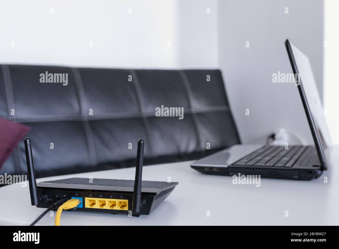 Modern wi-fi router on light table in room Stock Photo