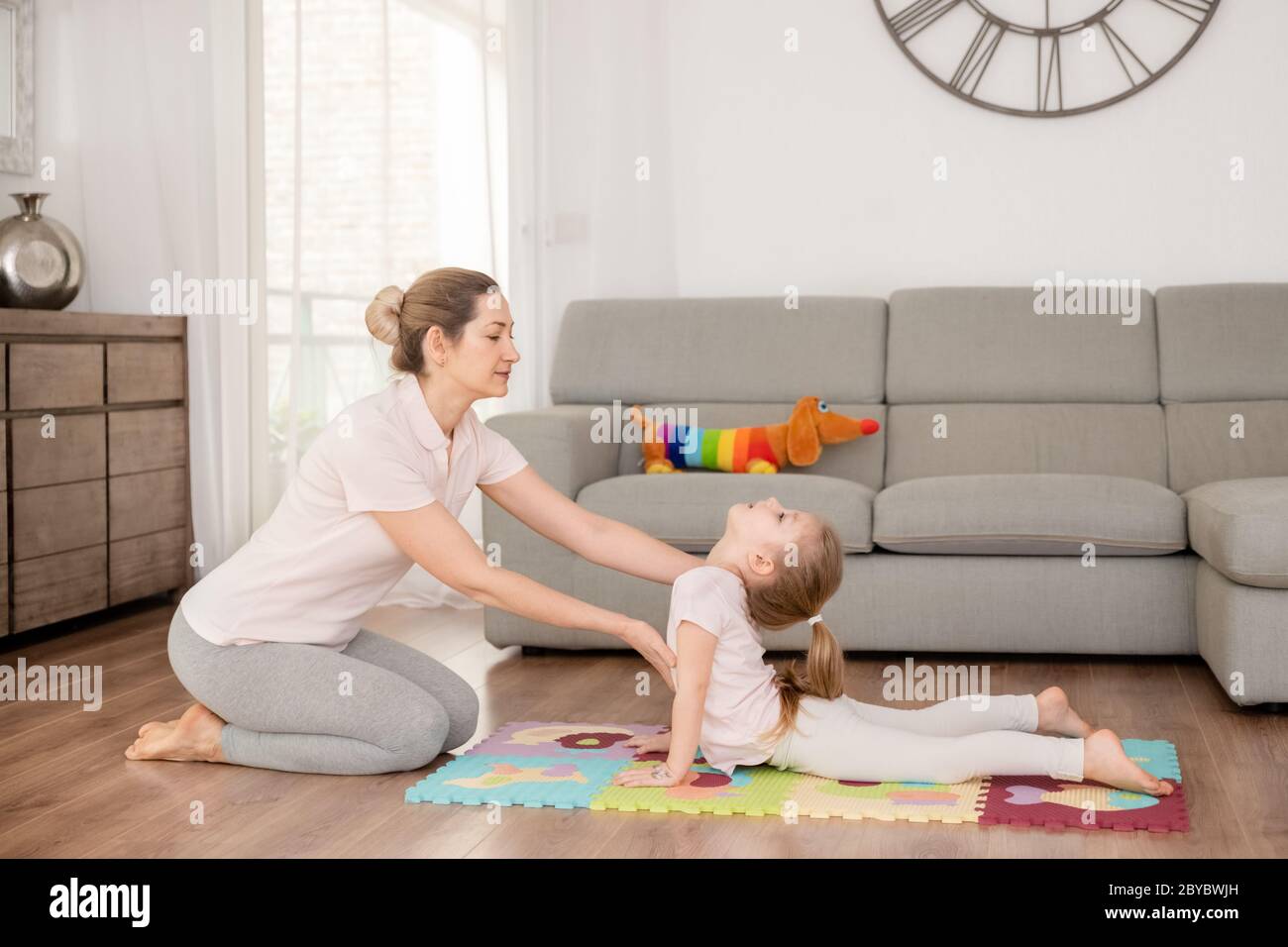 Mother and daughter doing yoga at home Stock Photo - Alamy