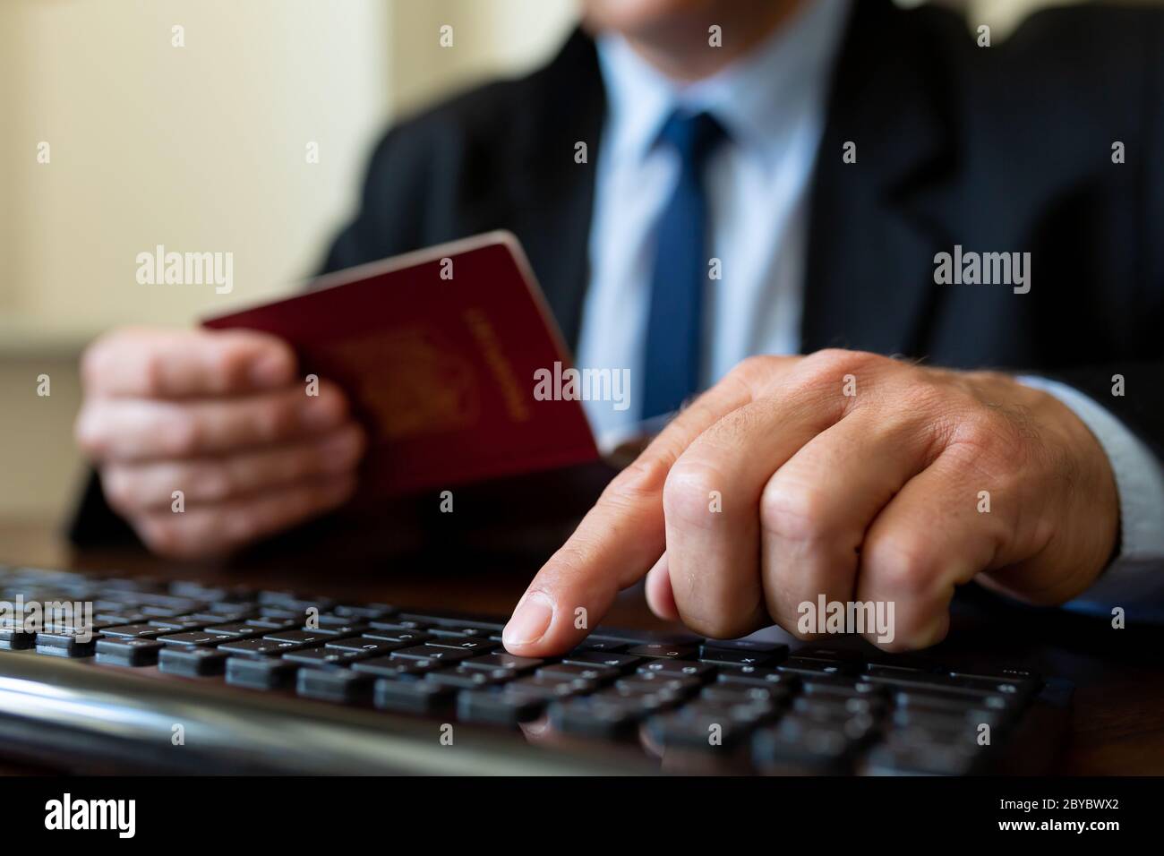 Close up. The immigration control officer verifies passport identification data. Stock Photo