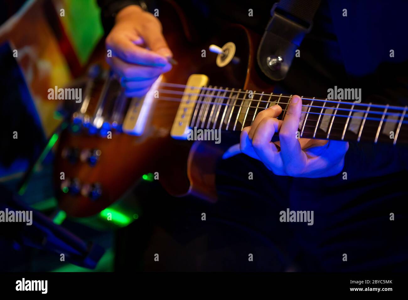 Close up. Artist Guitarist hand play electricity guitar on concert