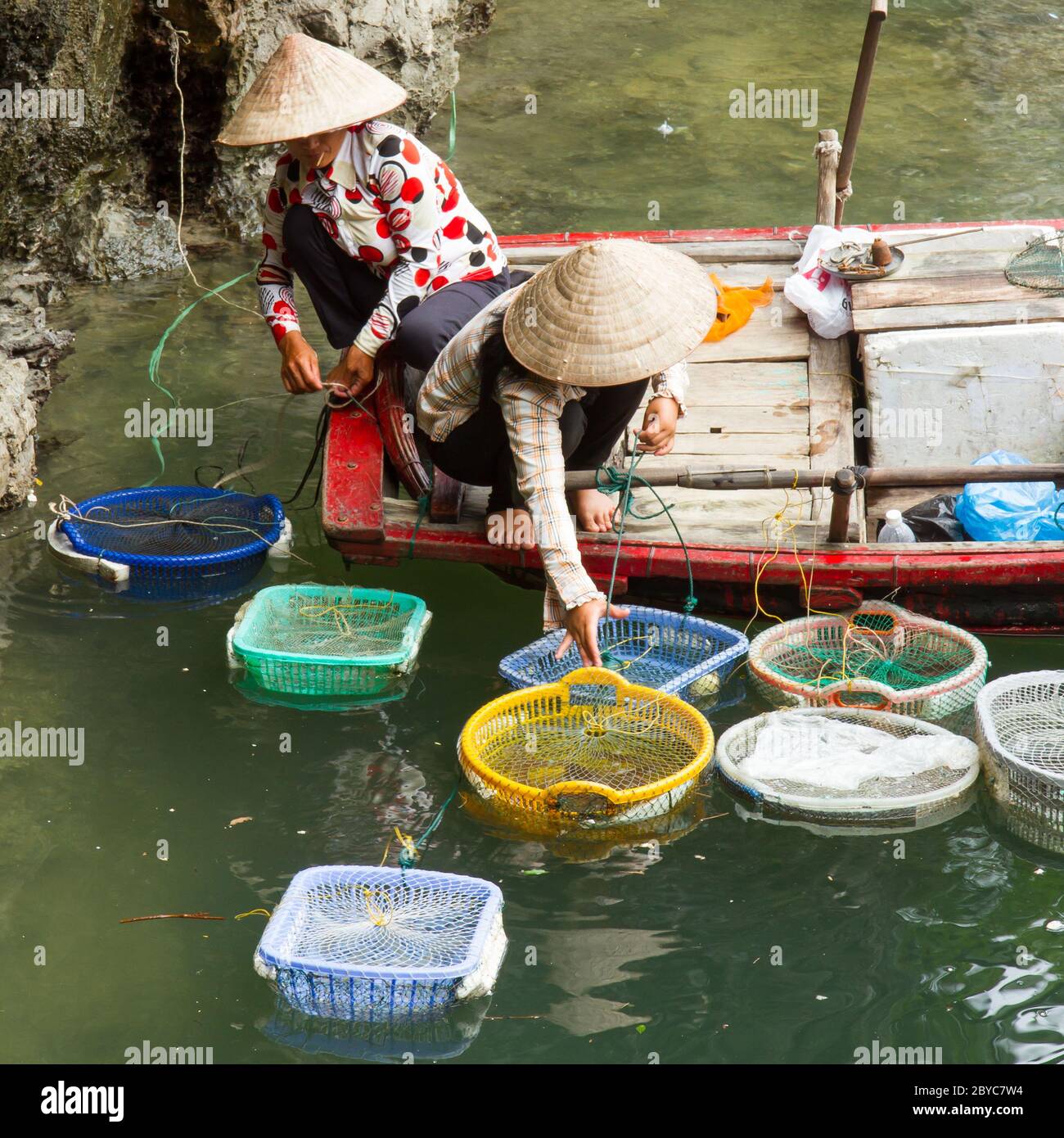 HA LONG BAY, VIETNAM AUG 10, 2012 - Food seller in boat. Many Vietnamese people try to sell different goods to tourists. Ha Long Stock Photo