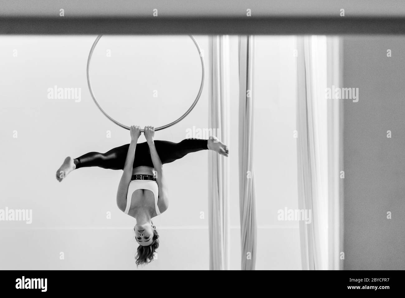 A Colombian aerial dancer performs on aerial hoop during a training session in a gym in Medellín, Colombia. Stock Photo