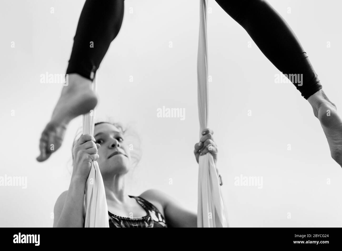 A Colombian aerial dancer holds aerial silks during a training session in a gym in Medellín, Colombia. Stock Photo