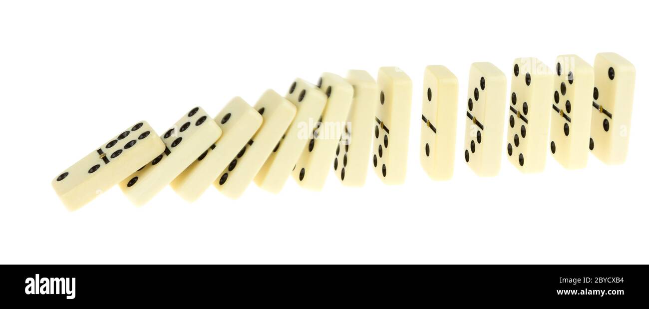 Long train of dominoes falling over Stock Photo