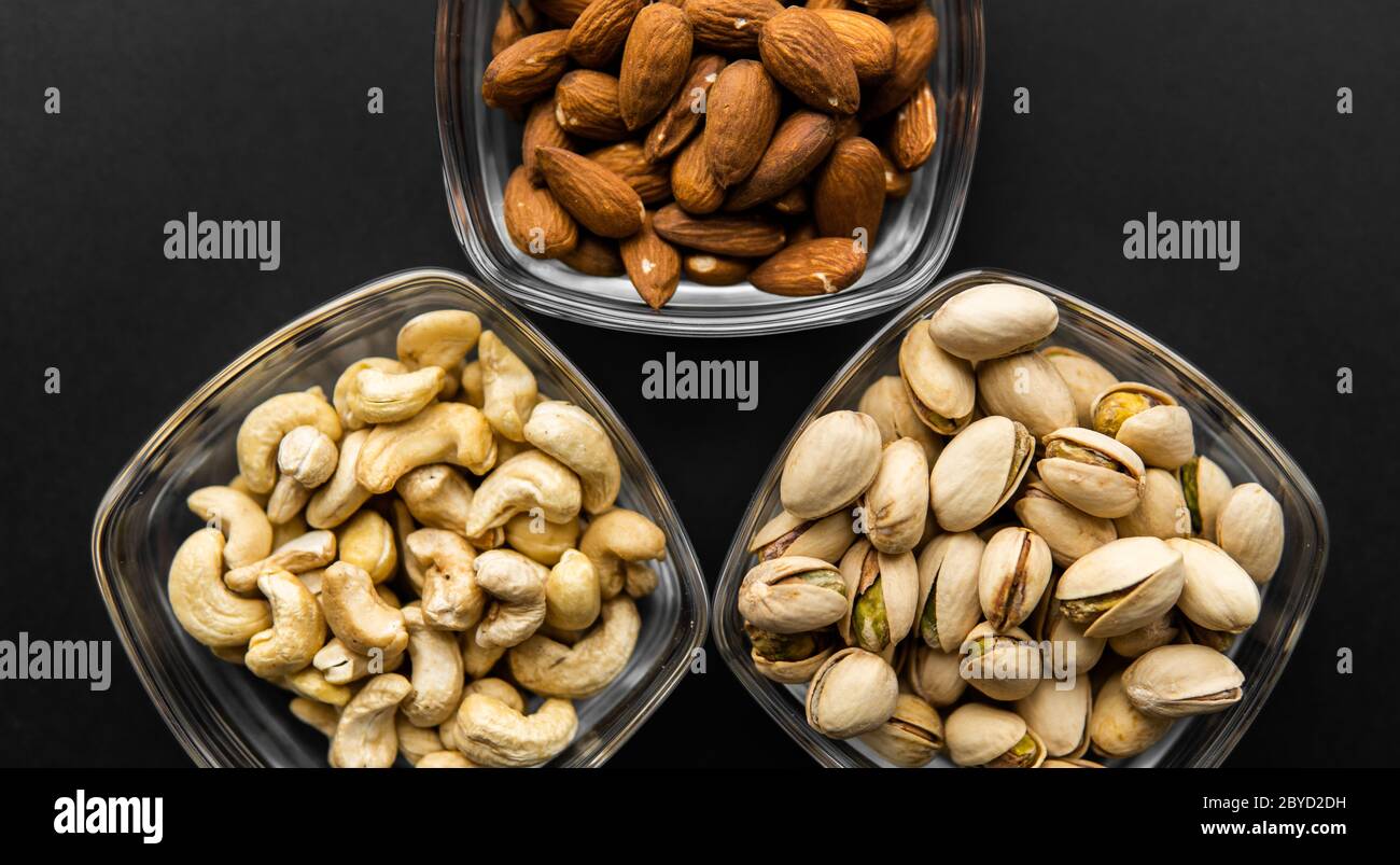 Almond, pistachio and cashew in a small plates which standing on a