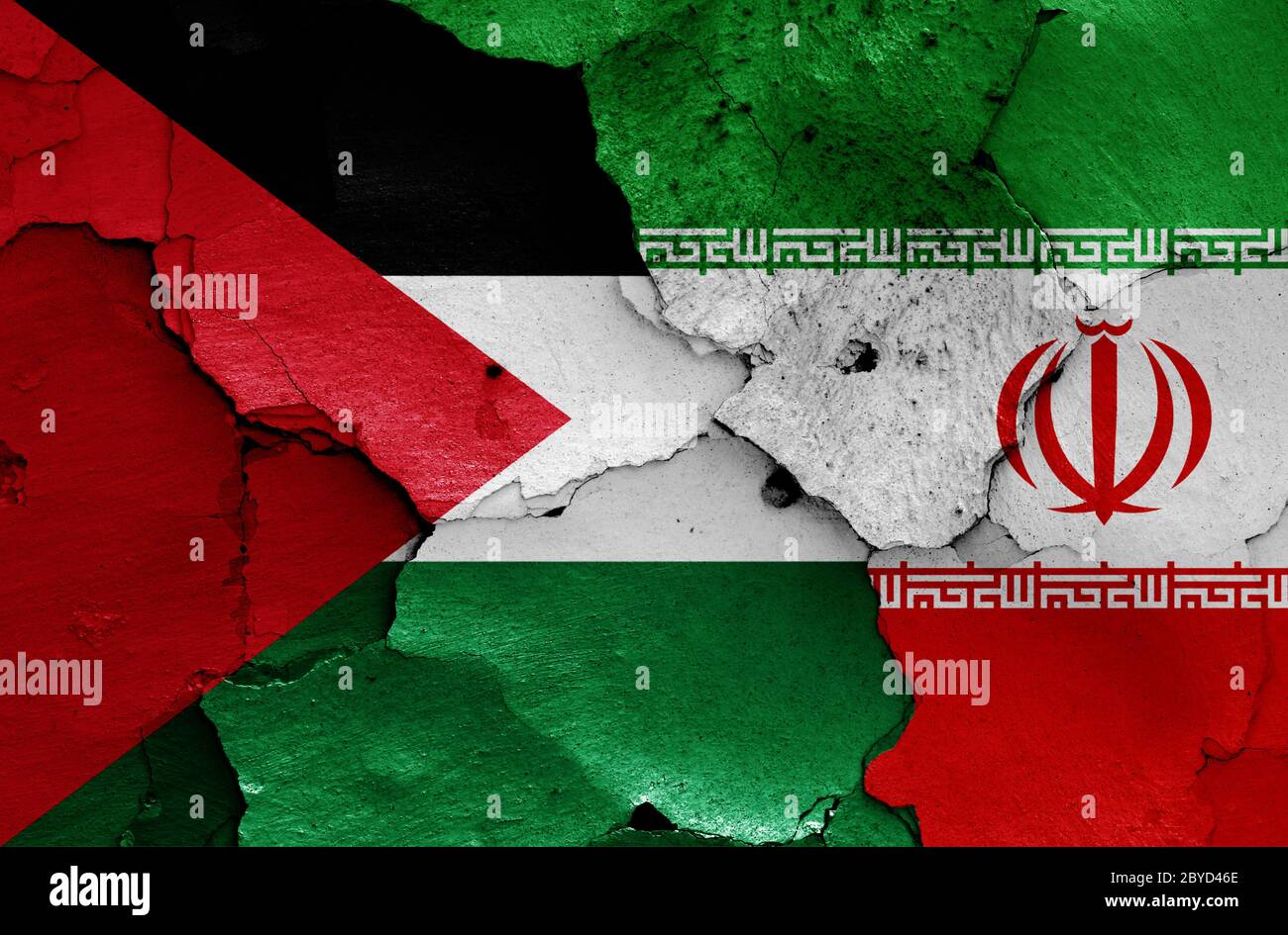flags of Palestine and Iran painted on cracked wall Stock Photo