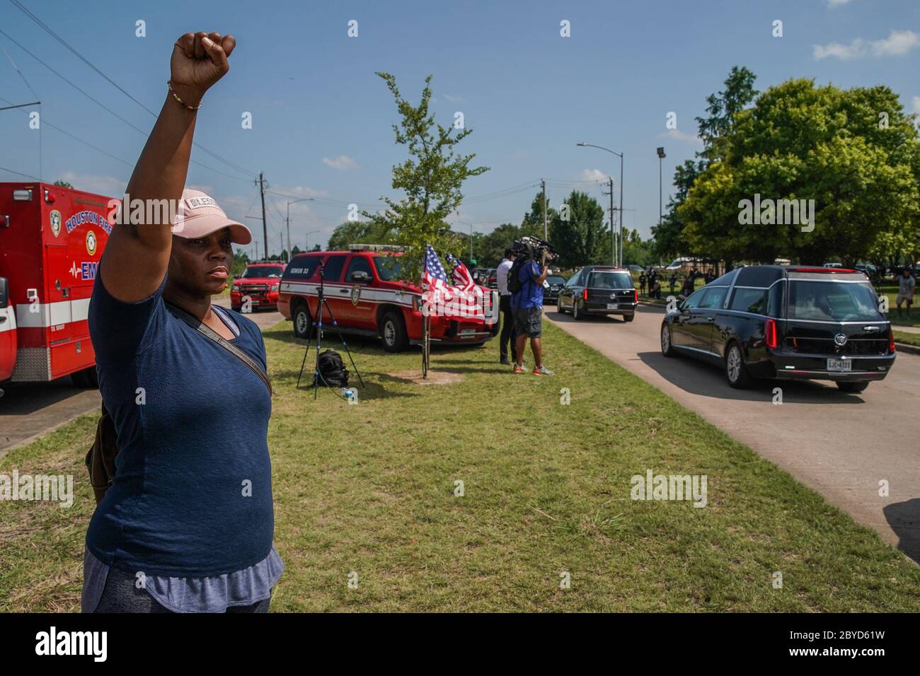 Houston, United States. 09th June, 2020. A woman raises her fist in salute as the hearse carrying the body of George Floyd to Houston Memorial Gardens passes the Fountain of Praise church in Houston, Texas on Tuesday, June 9, 2020. George Floyd died in police custody in Minneapolis, Minnesota on May 25, 2020. His death sparked demonstrations globally to combat racism and legislation in Congress for reforms. Photo by Jemal Countess/UPI Credit: UPI/Alamy Live News Stock Photo