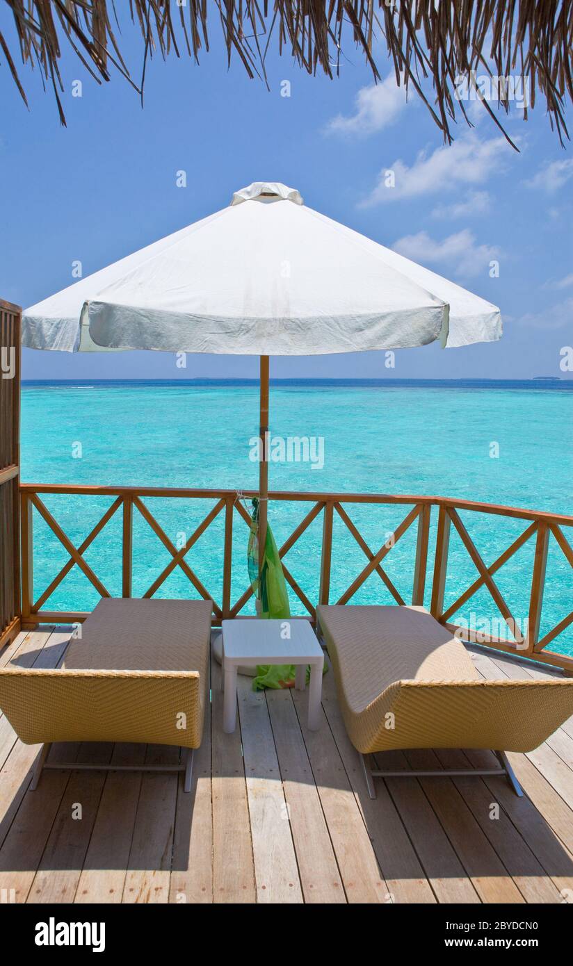 chaise lounges on a terrace of water villa, Maldiv Stock Photo Alamy