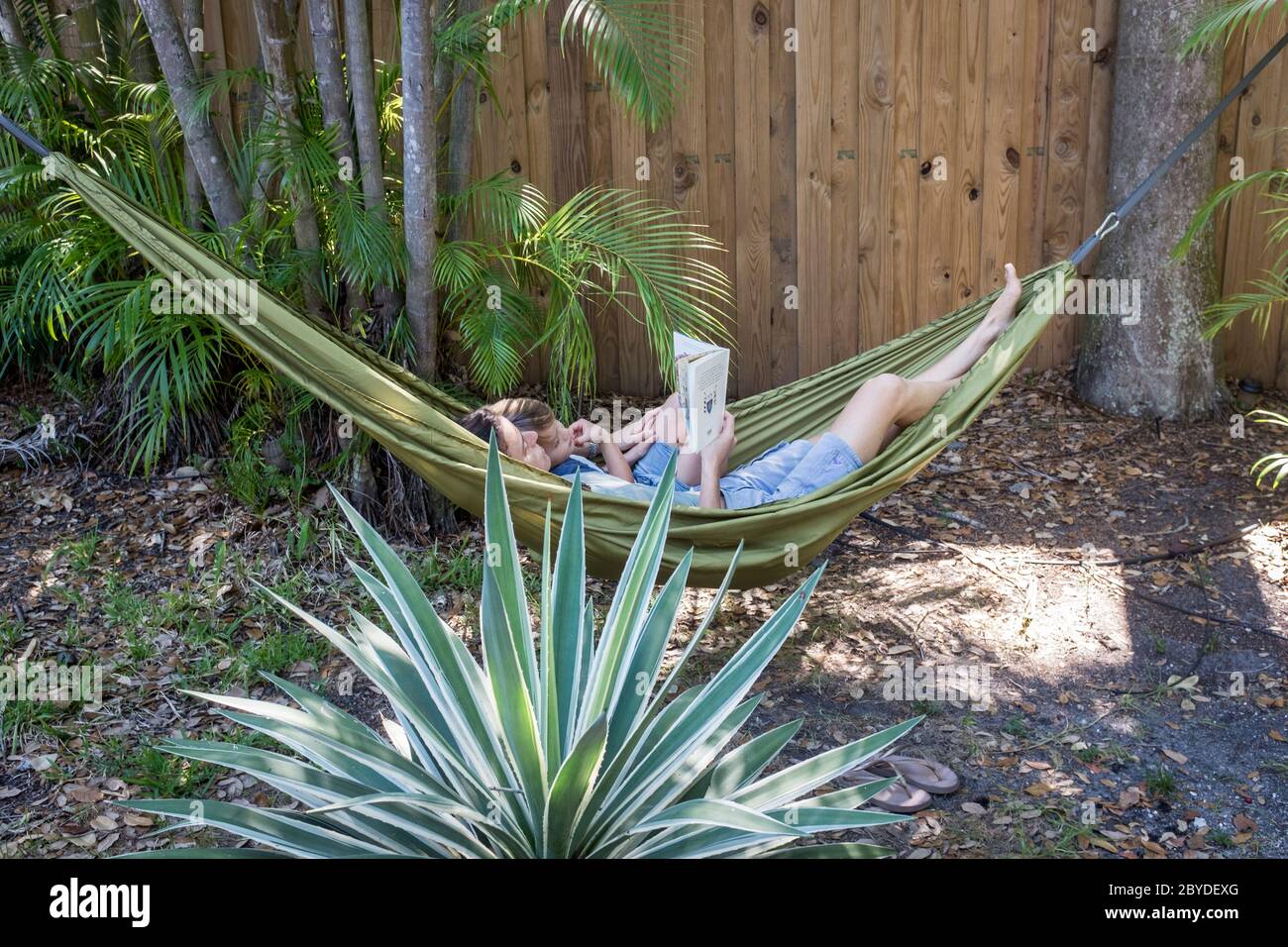 High angle view of a mother and her little boy lying in a hammock ...