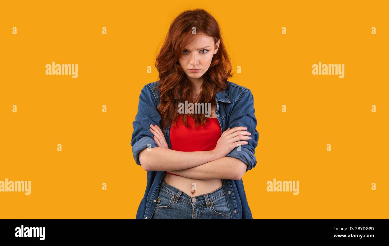 Discontented Millennial Girl Sulking Standing On Yellow Background, Panorama Stock Photo