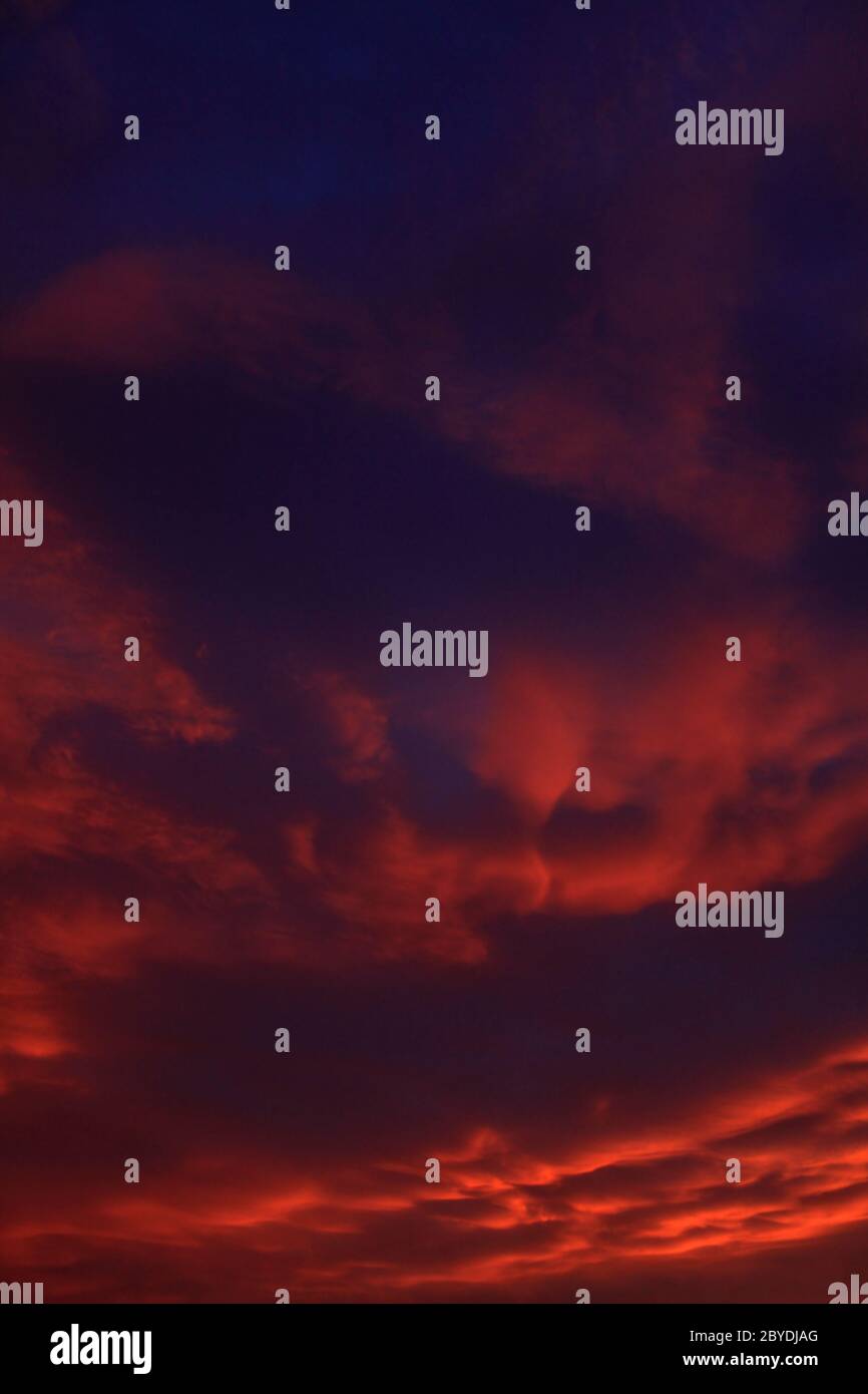 dramatic sky with orange clouds after sunset Stock Photo