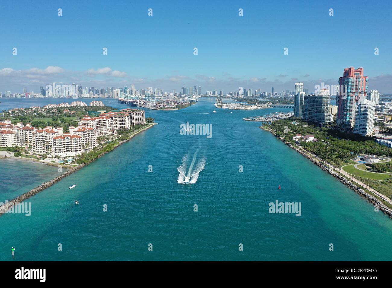 Aerial view of Fisher Island, South Pointe and Government Cut with City of Miami skyline and Port Miami in background. Stock Photo