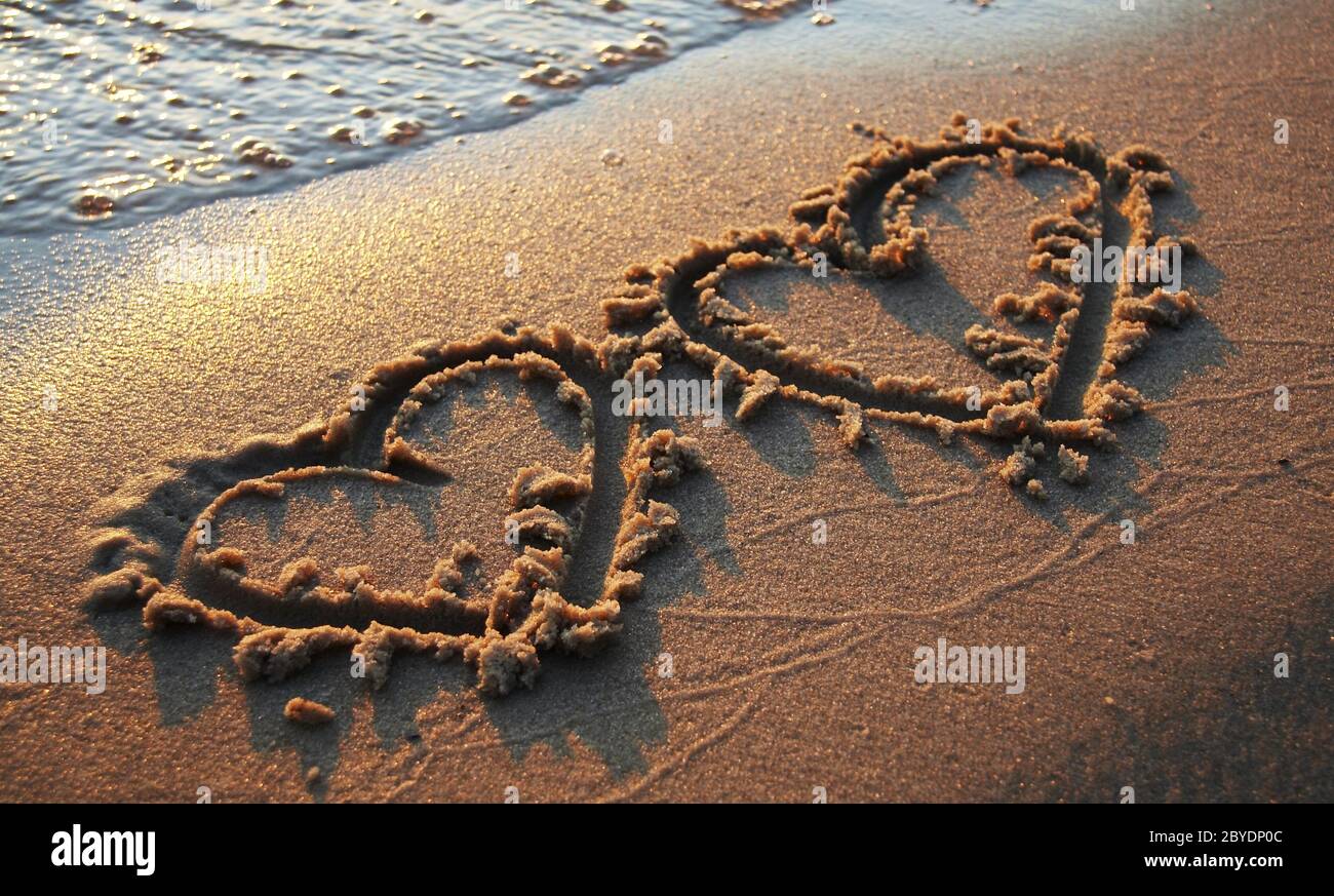 Two hearts on sand Stock Photo