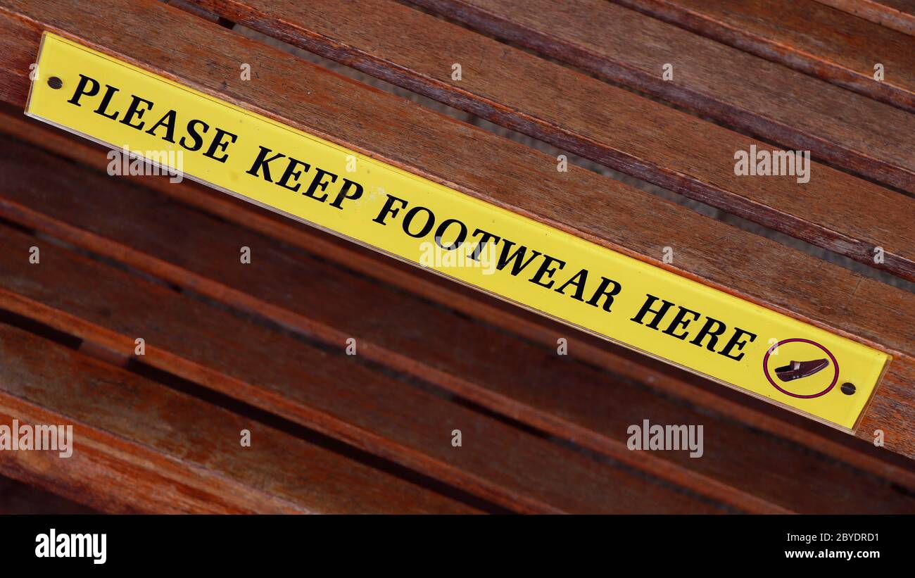 footwear storage sign board for public usage Stock Photo - Alamy